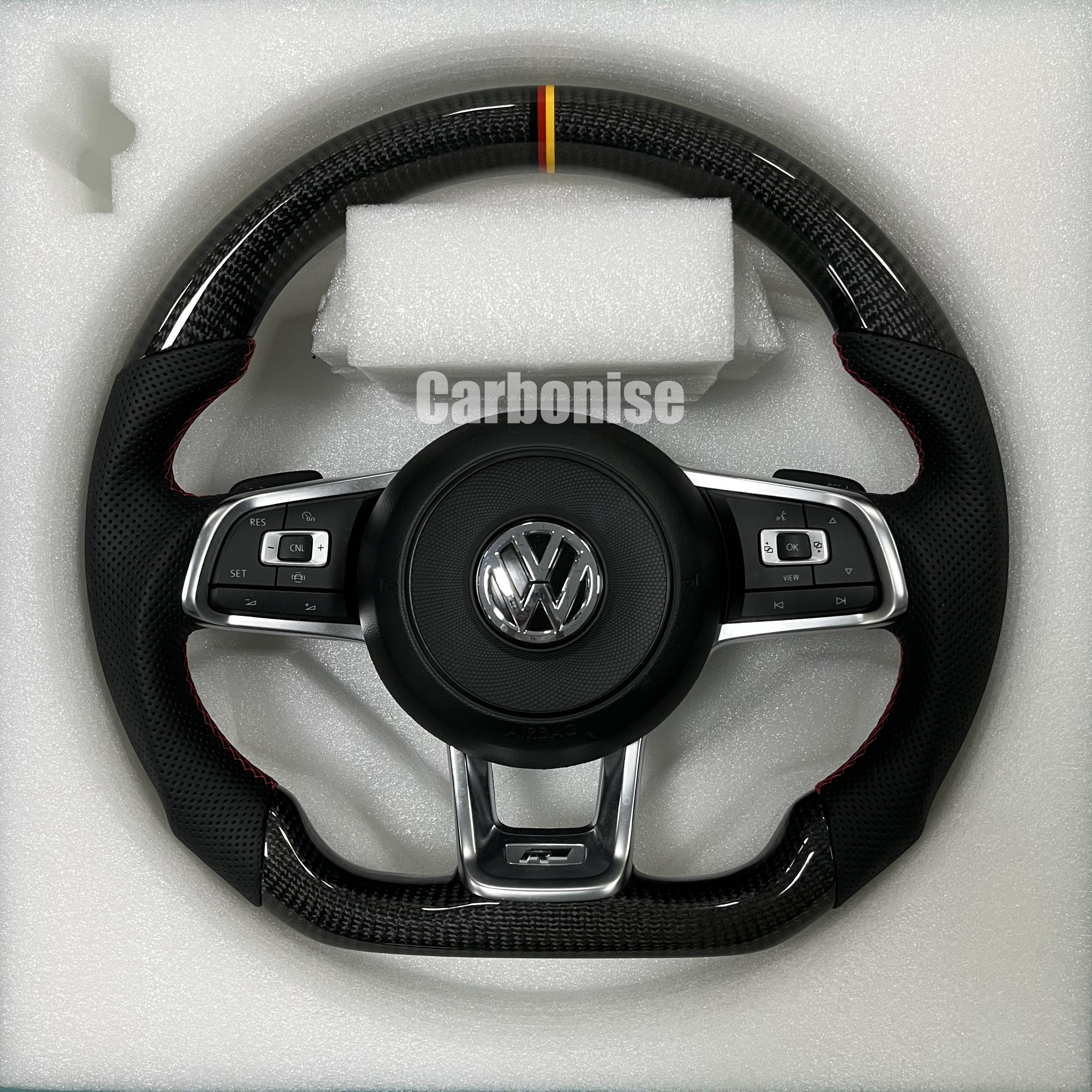 Custom Volkswagen performance steering wheel featuring high-gloss carbon fiber, a tricolor top racing stripe, and black perforated leather side grips.