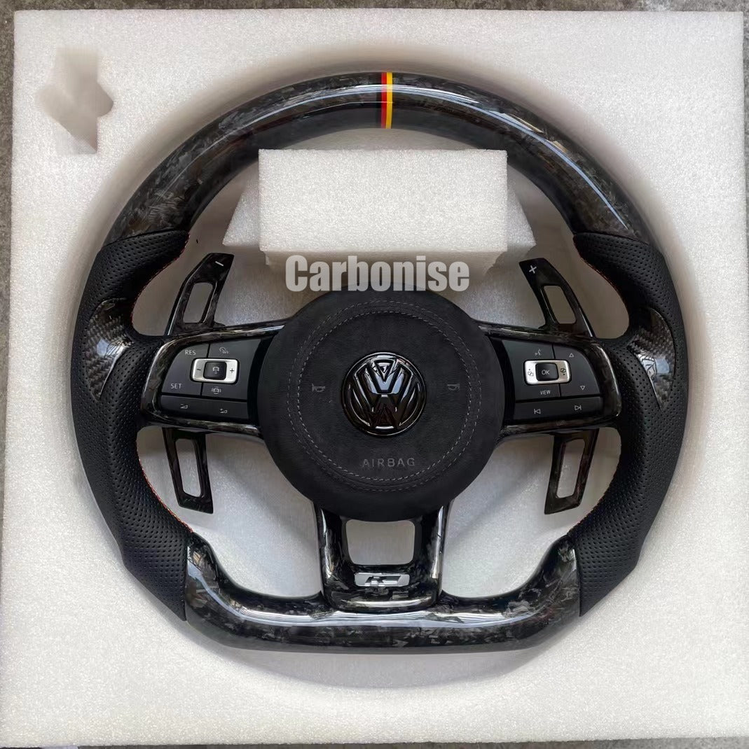Custom Volkswagen performance steering wheel featuring high-gloss marbled forged carbon fiber, a tricolor top racing stripe, and black perforated leather side grips.